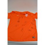 A Holland football shirt signed by 11 players from