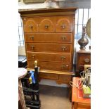 A Queen Anne style walnut chest on stand with three shaped drawers above four long drawers on