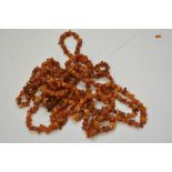 Two long strands of reconstituted amber beads