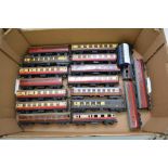 A box containing a collection of unboxed Hornby "OO" gauge railway carriages