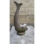 Heavy cast metal door stop in shape of a fish. Has been used outdoors as a garden feature