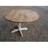 Circular pine dining table in rustic style with scrubbed top and painted single pedestal base