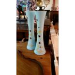 Pair of light blue tall glass vases. Each with hand painted floral design 42cm