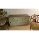 Wooden chest with drawers and doors, linenfold carving to front panels, painted in a very pale green