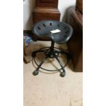 Tractor seat style, black, swivel stool on castors. Adjustable height.