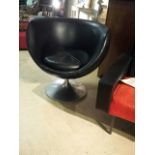 1970's swivel chair, circular, chrome/aluminium base. Black shell and cushion