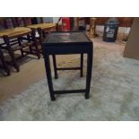 Oriental style side table. Decorative carving detail to top with bow legs. Approx: 40cm wide at