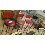 *4 vintage metal diner stools, tall bar stool style. 3 red, 1 black. One has a mis-shapen lower leg.