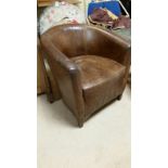 Chestnut brown leather tub chair. Mild cracking to arms and seat edge. Measures approx: 64cm wide,