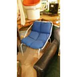 Mid century modern inspired chair. White metal frame with removable blue seat cushion. Item measures