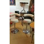 Pair of gas lift bar stools / breakfast chairs in faux cream leather and chrome bases. One has 2 pen