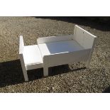 Extending wooden child's bed in white.