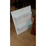 Painted white metal wall magazine holder with heart motif