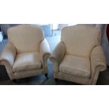 Pair of contemporary armchairs with a cream floral fabric. Turned front legs to brass castors.