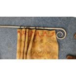 Hand forged iron curtain pole with pair of lined tapestry style curtains.