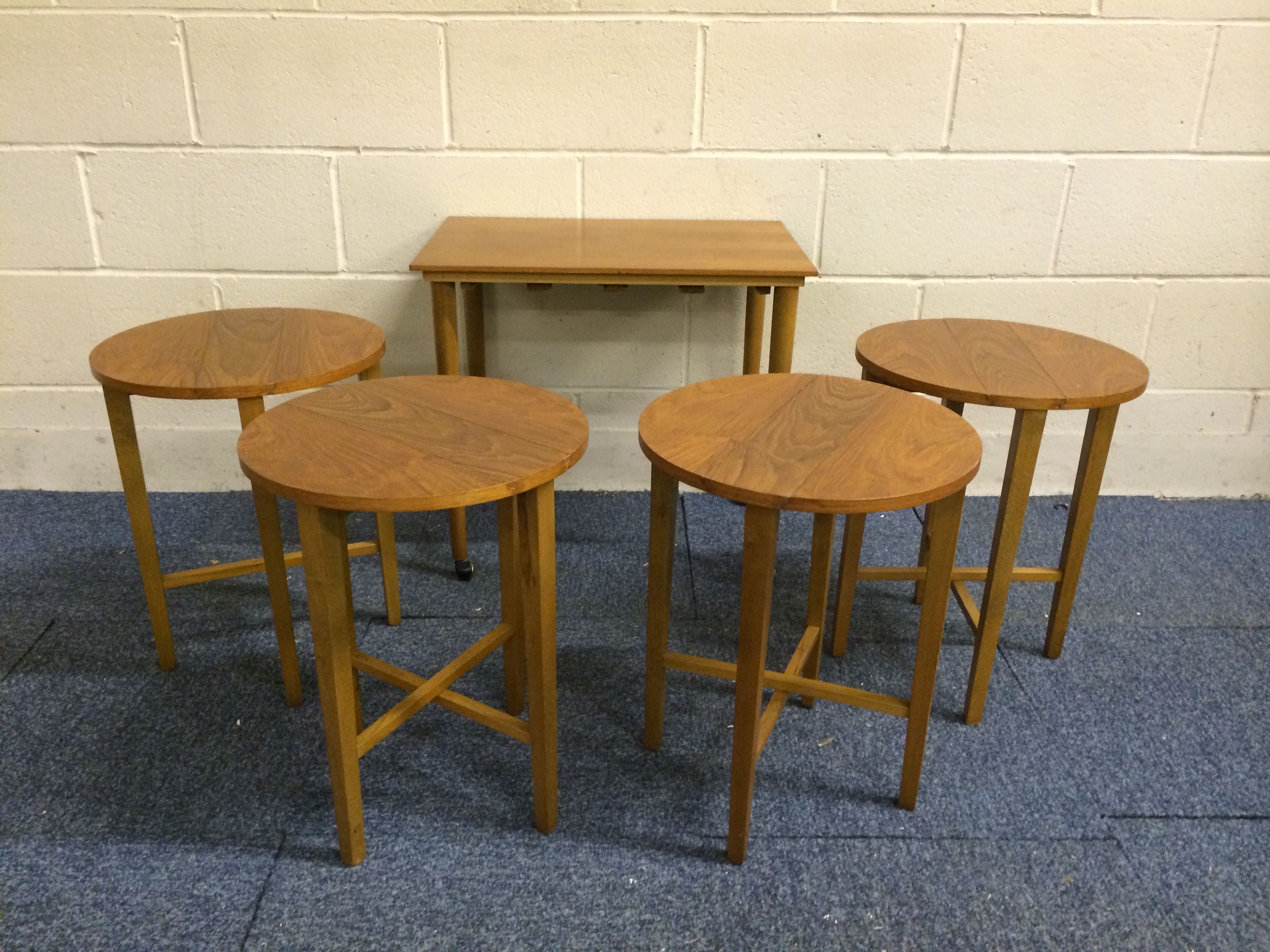 Very nice mid 20th century teak retro tables set..with 4 small circular tables stored under the main