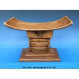 A hand carved 19th/20thC African Ashanti head rest/ pillow with added finish and stepped base