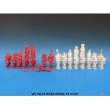 A 19thC Chinese ivory puzzle ball chess set, one side stained red,