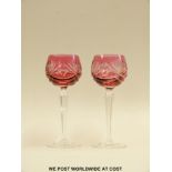 Pair of flash overlaid cranberry hock glasses with cut decoration on hexagonal stems,