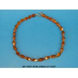 An amber necklace of 29 faceted translucent beads