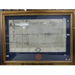 A framed document in latin script with gilt illumination and wax seal (width 84cm)