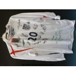 An England football shirt signed by 15 of the U21 team in 2005 together with three England t-shirts