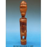 A wooden ancestor figure possibly from the Fimor tribe,