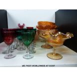 Sixteen various cranberry and blue glass wine glasses together with a collection of carnival glass,