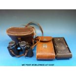 A cased pair of Hilkinson 8x30 binoculars together with a cased folding camera