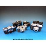 A box of approximately 20 mixed cameras including Canon, Praktica,