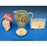 A collection of Clarice Cliff to include a jug, a face mask,