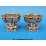 A pair of 18thC / 19thC Chinese silver salts with repousse decoration of trees and flowers (5cm