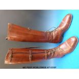 An early 20thC pair of vintage brown leather lace-up and buckled riding boots with "Phillips