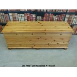 A pine blanket box raised on bun feet (L136 x D43 x H50cm)