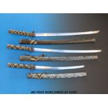 A graduated set of Samurai swords in ornate snakeskin scabbards; the blades 43cm,