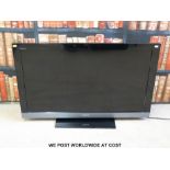 Sony Bravia 40" flatscreen TV with stand and wall mount.