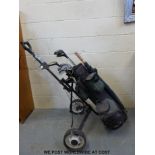 Two sets of golf clubs with trolleys