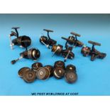 Six Mitchell fixed spool fishing reels and a quantity of spare spools for various reels.