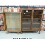 Two glazed display/bookcases, one with ministry broad arrow to rear.