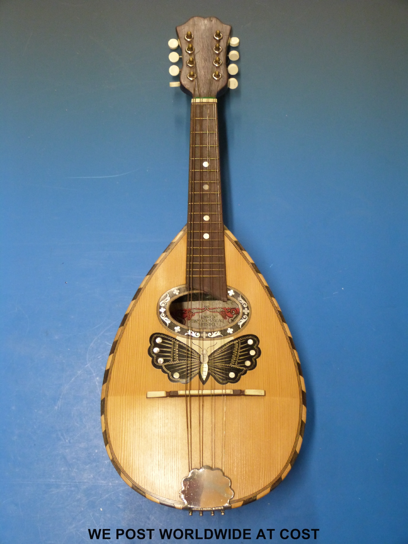 A cased c1920 Ermelinda Silvestri Catania mandolin decorated with butterfly inlay and mother of