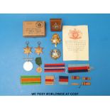 Three WWII medals, together with a Dorsetshire Regiment cap badge, and one other,
