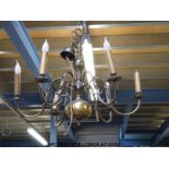 A metal six branch chandelier fitted for electricity with stylised animal decoration