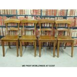 A set of four solid seat dining chairs