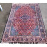 A large wool Persian rug