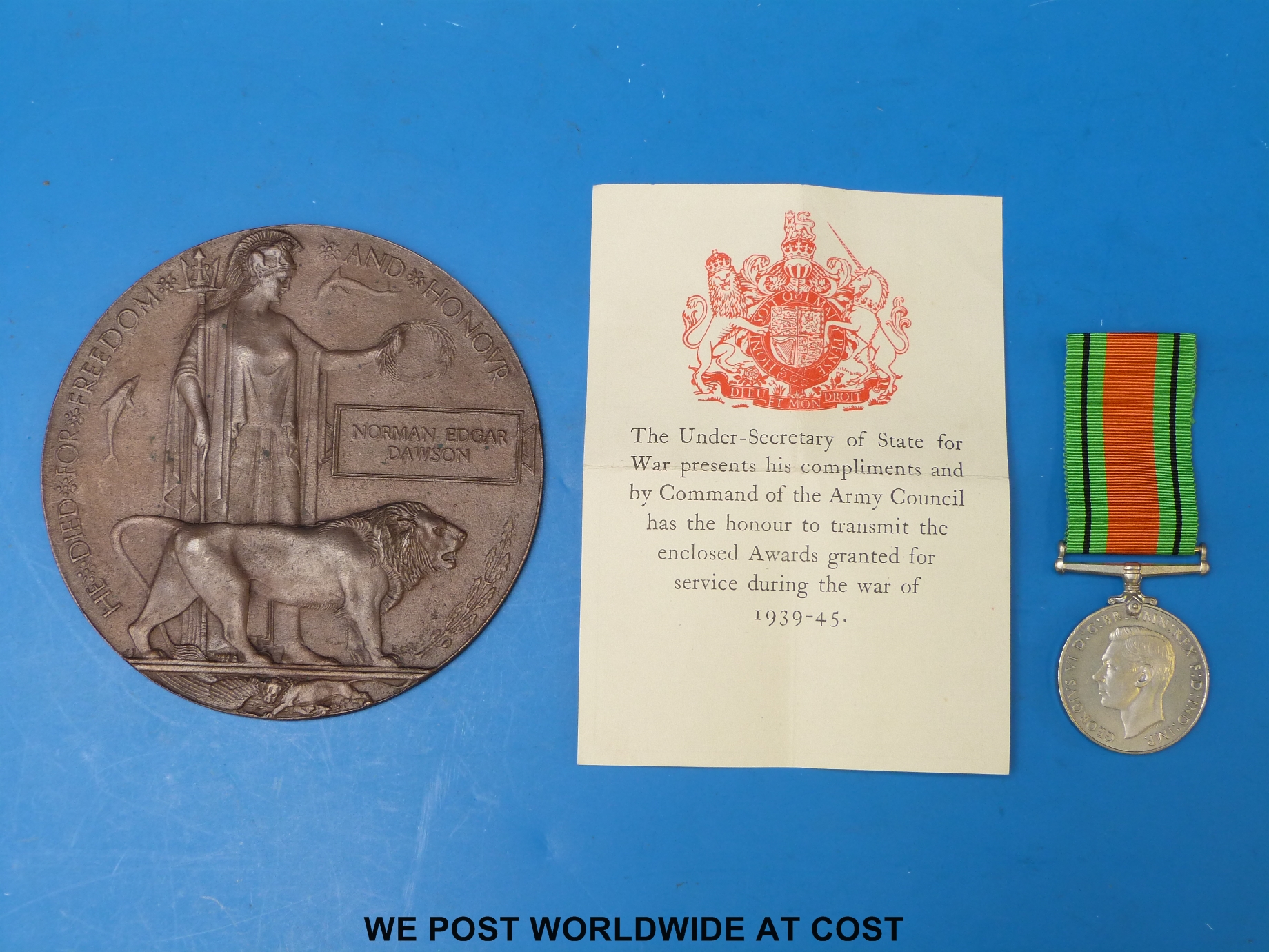 A WWI death plaque for Norman Edgar Dawson and a WWII defence medal