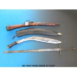 An Eastern style gun, kukri, a sword and a folding knife.