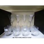 A set of eight cut glass wine glasses together with eight matching whisky tumblers