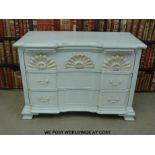 A painted breakfront chest of three drawers (width 107cm) and a wicker coffee table with glass top