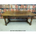 A large oak extending dining table with shaped and moulded stretchers (min length 198, max 290cm,