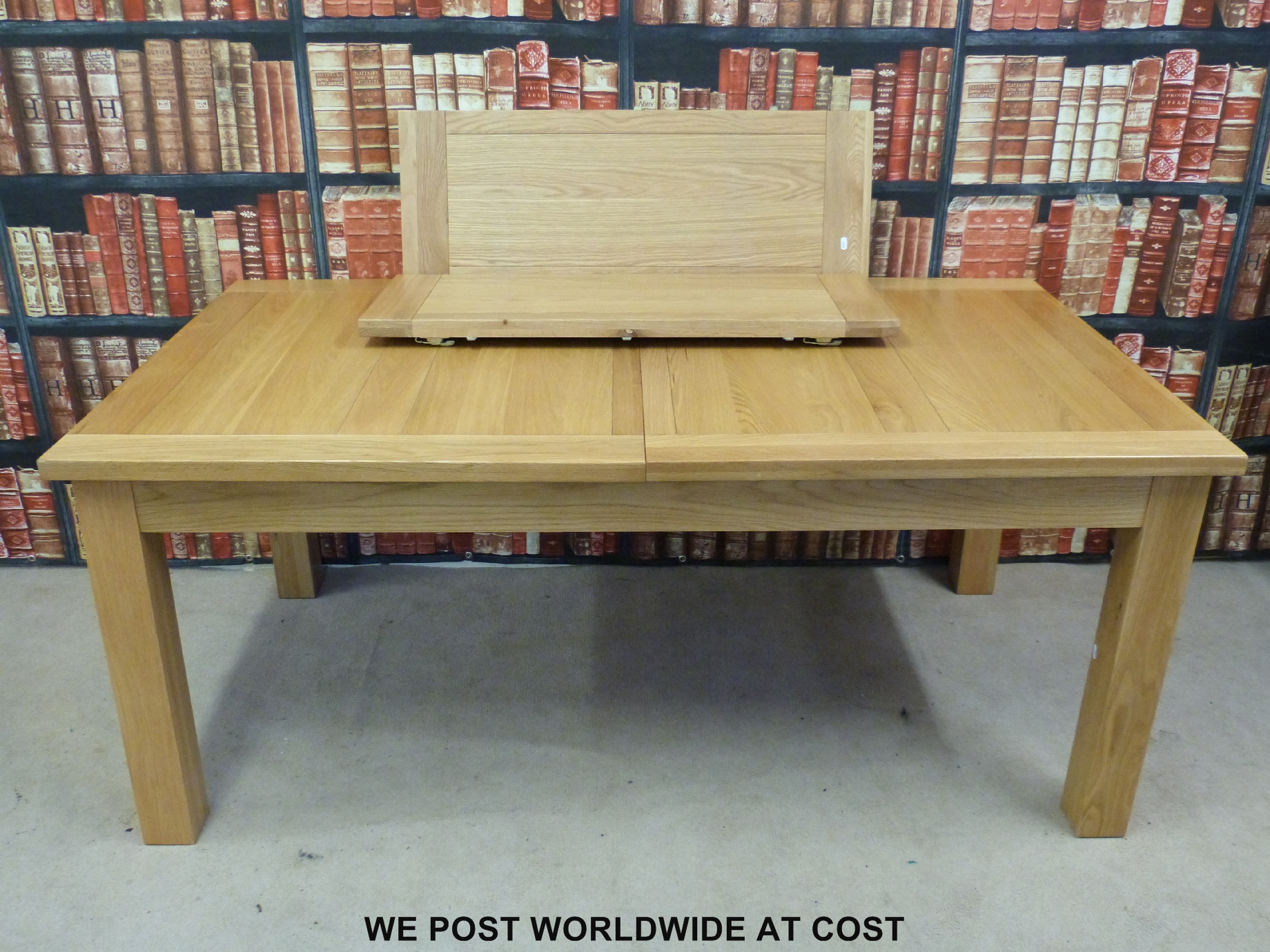 A contemporary light oak dining table with two extra leaves (min length 181cm, max 256cm,